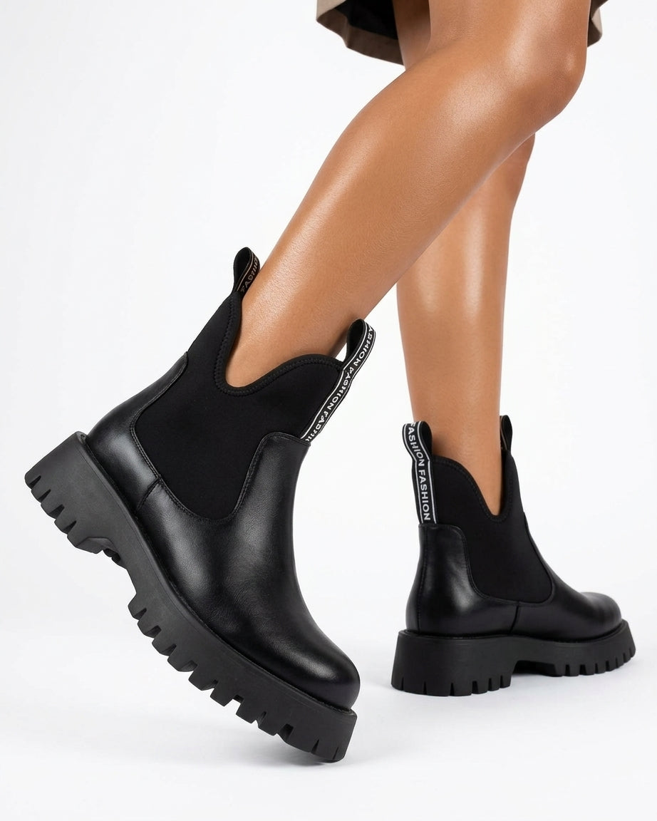 Leather boot with lug sole and side elastic